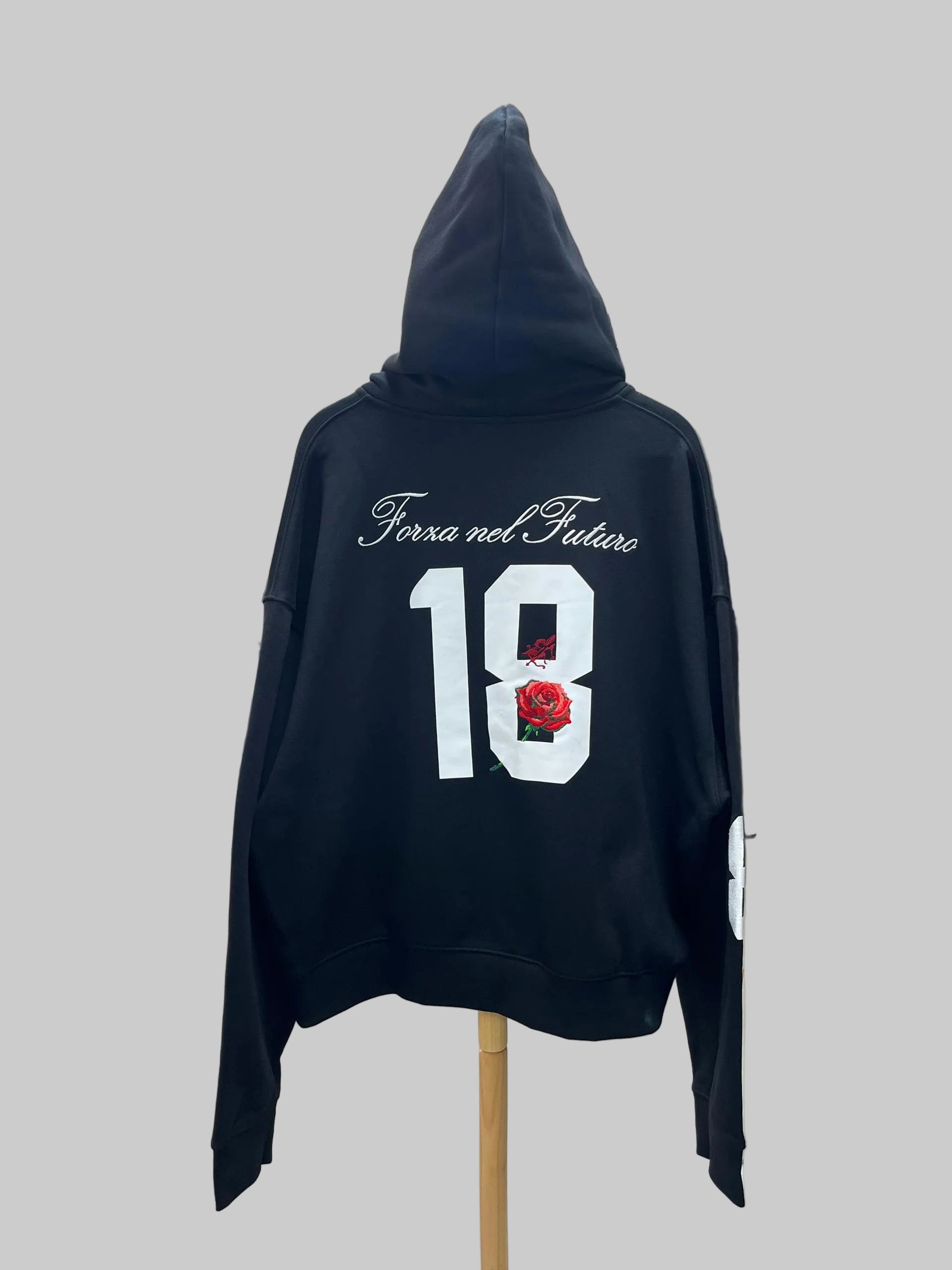 Black hoodie with text and number on a gray background