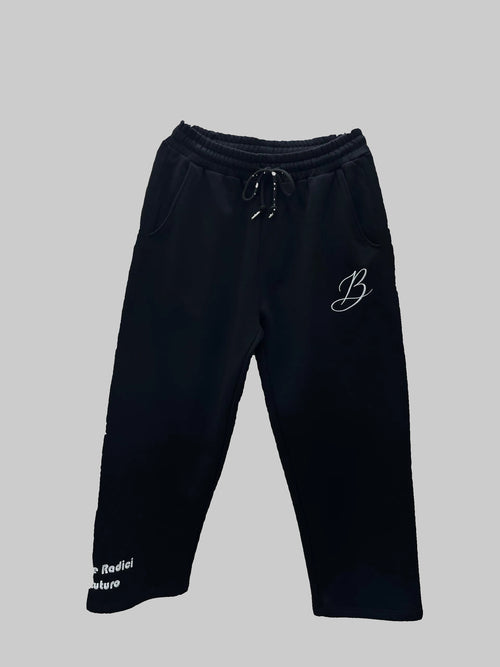 Black sweatpants with a logo on a gray background